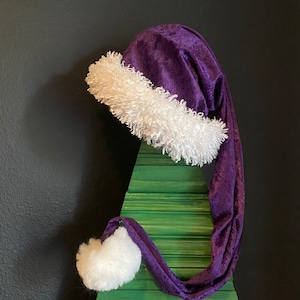 Purple crushed velvet with white furry fleece trim and 3 inch Pom Pom