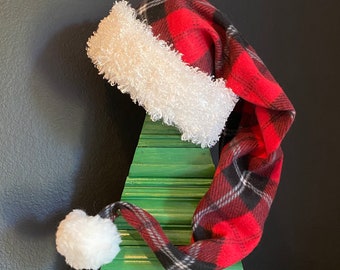 Red/Black plaid fleece with white furry fleece trim and 3 inch pom pom