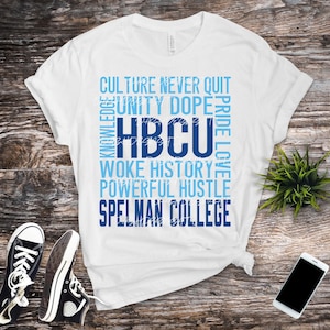 May include: White t-shirt with blue text that reads "CULTURE NEVER QUIT UNITY DOPE HBCU PRIDE LOVE WOKE HISTORY POWERFUL HUSTLE SPELMAN COLLEGE"