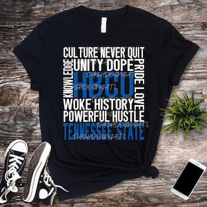 May include: Black t-shirt with white text that reads "Culture Never Quit, Unity Dope, Knowledge, HBCU, Pride Love, Woke History, Powerful Hustle, Tennessee State". The text is stacked vertically and the words "HBCU" and "Tennessee State" are in blue.