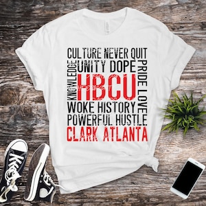 May include: White t-shirt with black and red text. The text includes words like "Culture," "Unity," "HBCU," and "Clark Atlanta." Black canvas sneakers and a smartphone are also visible.