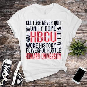 May include: White t-shirt with the text "HBCU" in red, surrounded by words like "Culture," "Unity," and "Howard University" in a navy blue font. Black Converse sneakers and a smartphone are also in the image.