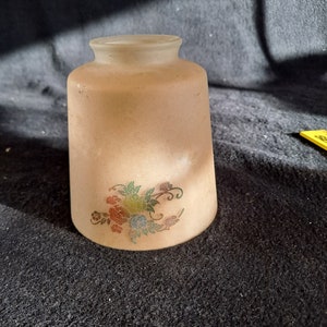 May include: A frosted glass lampshade with a floral design in shades of red, green, blue, and pink.