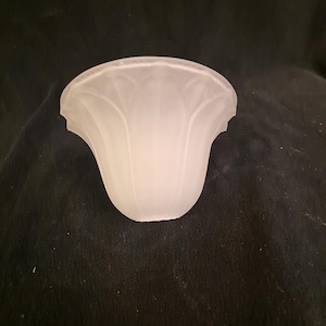 May include: A white frosted glass lampshade with a scalloped edge and a fluted design.