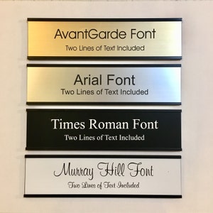 May include: Four different nameplates with black borders. Each nameplate has a different font style and the text "Two Lines of Text Included". The fonts are AvantGarde, Arial, Times Roman, and Murray Hill.