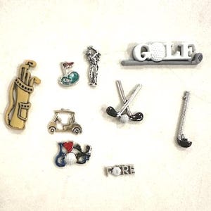 May include: A set of nine golf-themed charms, including a golf bag, golf cart, golf clubs, a golf ball, and the word "FORE".