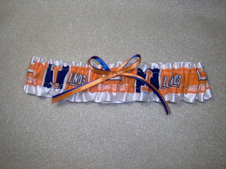May include: White satin garter with orange and blue ribbon and a blue and orange fabric insert with the text "ILLINOIS" printed on it.