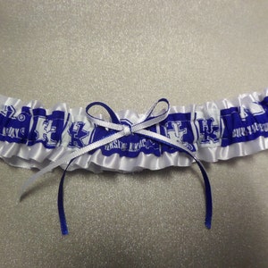May include: White and blue satin garter with a blue bow and the text "University of Kentucky" repeated on the band.