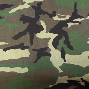 Puede incluir: Tela de camuflaje con un patr&oacute;n de formas verdes, marrones y negras.