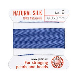May include: A spool of blue natural silk thread, labeled "NATURAL SILK No. 6". The label also indicates the thread is 100% Naturseide with a diameter of 0.70 mm. Text on the label reads "For stringing pearls and beads".