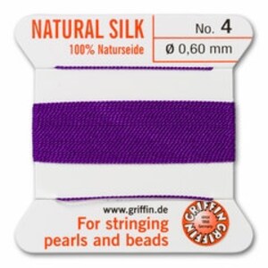May include: A spool of purple natural silk thread, labeled "NATURAL SILK No. 4" with a diameter of 0.60 mm. The label also states "For stringing pearls and beads" and includes the website www.griffin.de.