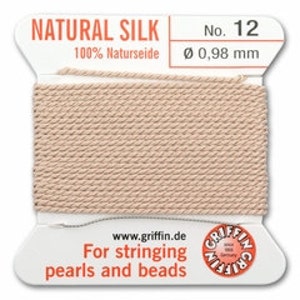 May include: A spool of natural silk thread, labeled "NATURAL SILK" and "No. 12." The thread is a light beige color, with a diameter of 0.98 mm. The label also includes the text "For stringing pearls and beads."