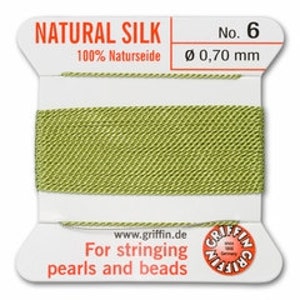 May include: A spool of natural silk thread, labeled "NATURAL SILK No. 6". The thread is a light green color, with a diameter of 0.70 mm. The label also includes the text "For stringing pearls and beads".