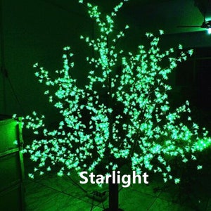 May include: A green LED light-up tree with a black base. The tree is decorated with small green lights that resemble blossoms. The text "Starlight" is visible on the base of the tree.