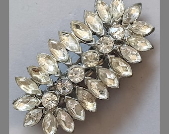 1950s white metal rhinestone brooch repurposed into a hair barette. ac-h-0164