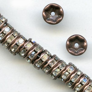 Clear rhinestone rondelle with antiqued copper. 4.5mm. Pkg of 4. b18-0270-1