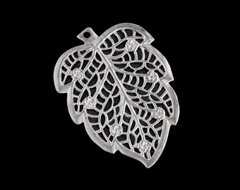 Op de afbeelding: Zilveren bladeren hanger met een delicaat, ingewikkeld ontwerp. Het blad heeft een filigraanpatroon en is versierd met kleine, heldere strass steentjes.