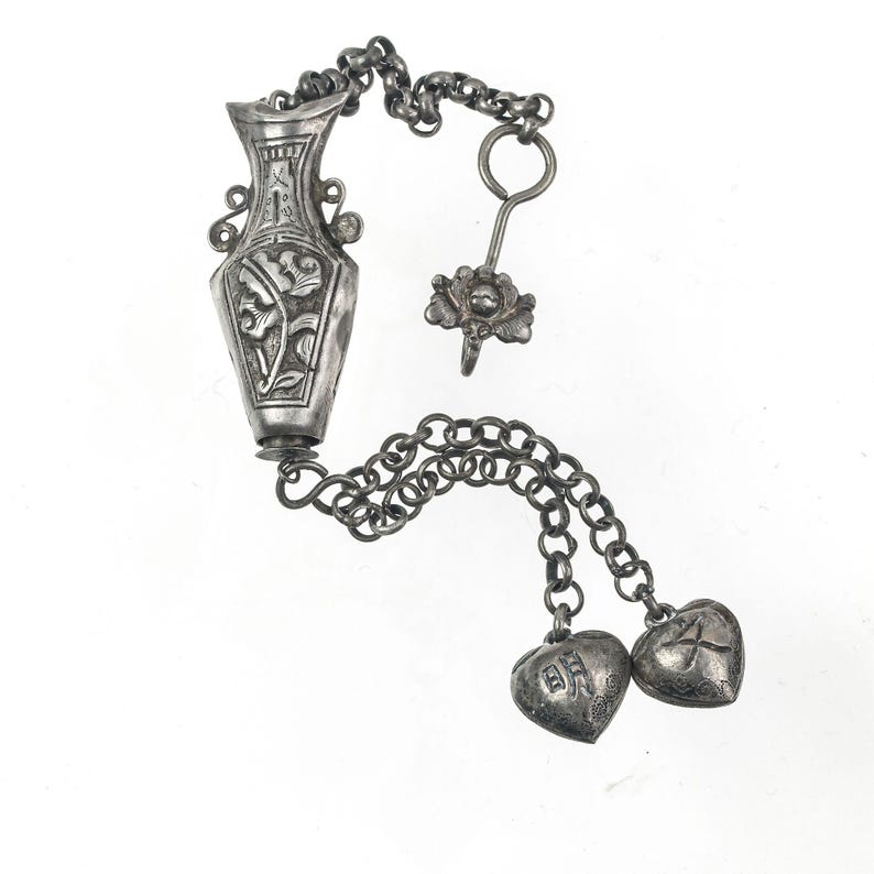 Antique Chinese Qing Dynasty silver repoussé needle case with charms and chatelaine clip. pdvs1009