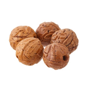 May include: Five brown wooden beads with intricate leaf patterns carved into the surface. The beads are round and have a hole through the center.