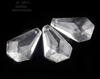 May include: Three clear glass teardrop-shaped crystal prisms with faceted edges.