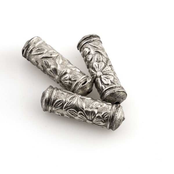 Silver plated hollow cylinder with stamped floral design. 20x6mm with 1mm hole. Sold individually. b18-583