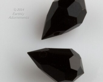 May include: Two black faceted teardrop-shaped crystal beads.