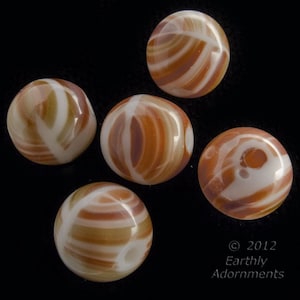 May include: Five round, white and brown agate beads with swirling patterns. The beads are smooth and polished.