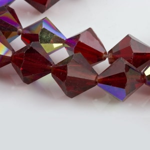 Vintage tin cut faceted translucent ruby red glass bicones with partial AB finish. Czechoslovakia. 1950-60s 10mm. Pkg of 8. b11-rd-0831-2