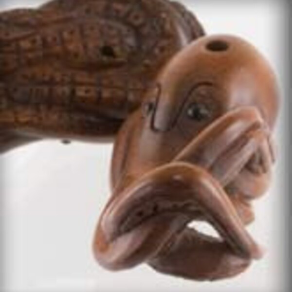 Hand carved boxwood octopus ojime bead. 14x24mm. Pkg. of 1. B7-WO212