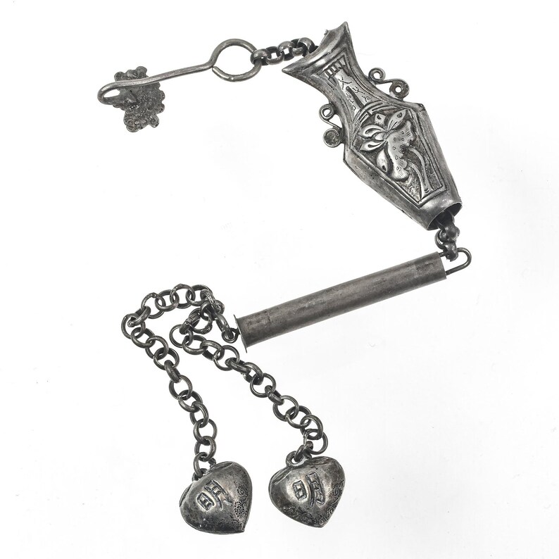 Antique Chinese Qing Dynasty silver repoussé needle case with charms and chatelaine clip. pdvs1009