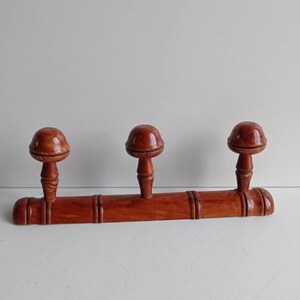 Mid Century Retro French vintage three peg bamboo style coat rack in darker stained wood circa mid century.
