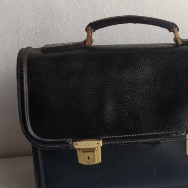 Shabby chic French vintage black leather briefcase with brass coloured locks and internal compartments.