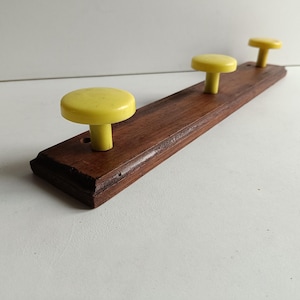 French vintage, Retro 3 yellow coloured coat rack in solid wood with plastic domes/hooks, circa 1970s.