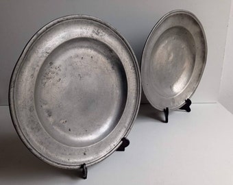 Pair of large antique rustic French pewter plates with aged patina with marks, stamps and family names engraved on base circa 1800s.