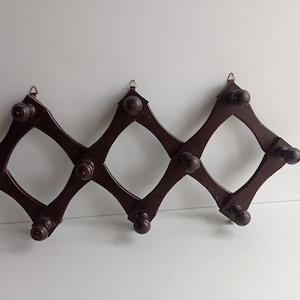 French vintage dark wood expanding / concertina 10 peg hat and coat rack circa 1970s.