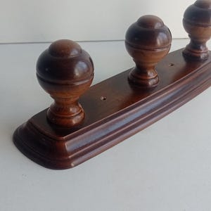 French vintage mahogany stained beechwood 3 peg coat rack with large domed pegs circa 1970s.