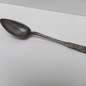 Large French antique pewter serving spoon with shaped bowl and handle.