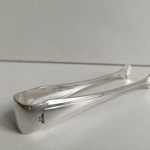 Christofle Art Deco antique silver plated sugar tongs with Geometric styling  and makers stamps circa 1910s.