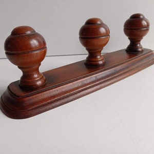 French vintage mahogany stained beechwood 3 peg coat rack with large domed pegs circa 1970s.