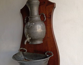 French antique heavy pewter fountain with basin and oak backboard mounting.