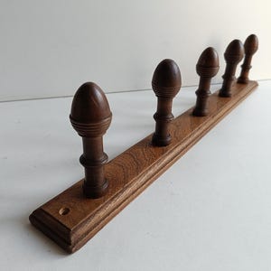 French vintage wood 5 peg  coat rack with cone like finials circa Mid century.