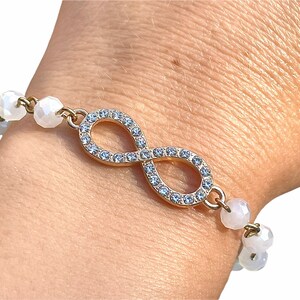 Rhinestone Infinity Bracelet with White Beaded Chain. Symbol bracelet. Beaded bracelet. White bracelet. Infinity symbol bracelet.
