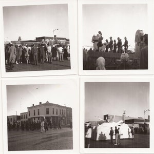 May include: Four black and white photographs of a parade. The first photo shows a group of people standing in front of a building with the text "John Probst Lumber Co." The second photo shows a float with a large white horse and a group of people on it. The third photo shows a group of people walking down a street. The fourth photo shows a float with a large white elephant and a group of people on it.