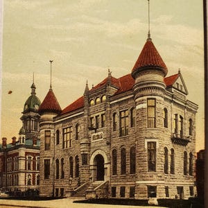 May include: Vintage postcard featuring Soldier's Memorial Hall in Wabash, Indiana. The building is constructed of light-colored stone with a red tile roof and multiple turrets. The text "Soldier's Memorial Hall, Wabash, Ind." is printed at the bottom.