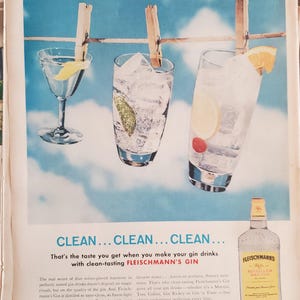 May include: Vintage advertisement for Fleischmann's Gin. Three cocktails with garnishes hang from clothespins against a blue sky backdrop. A bottle of gin is on the right. The text reads "CLEAN...CLEAN...CLEAN..." and describes the gin.