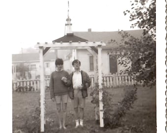 Trellis Love, 1965 Vintage Photograph, Black and White Photo, Vernacular Image, Fun Silly Photo of Young Man and Woman holding Hands