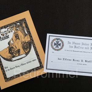 Könnte beinhalten: Ein schwarz-weißes Zertifikat mit einem schwarzen Eisernen Kreuz und dem Text "Im Namen Seiner Majestät des Kaisers und Königs" und "das Eiferne Kreuz II. Klasse".
