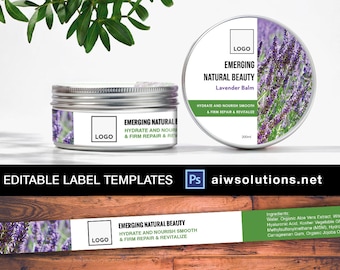 May include: A white label with the text "Emerging Natural Beauty" and "Lavender Balm" on a jar of lavender balm. The label also includes the text "Hydrate and Nourish Smooth & Firm Repair & Revitalize". The jar is sitting on a wooden surface with a sprig of lavender.