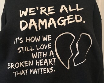 We're all damaged pullover hooded sweatshirt