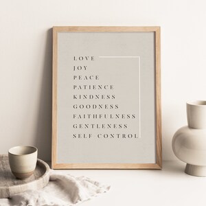 May include: A framed print with a beige background and black text. The text reads "Love, Joy, Peace, Patience, Kindness, Goodness, Faithfulness, Gentleness, Self Control".